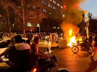 A police motorcycle burns during a protest over the death of Mahsa Amini, a woman who died after being arrested by the Islamic republic's "morality police", in Tehran, Iran September 19, 2022. (West Asia News Agency via Reuters//File Photo)