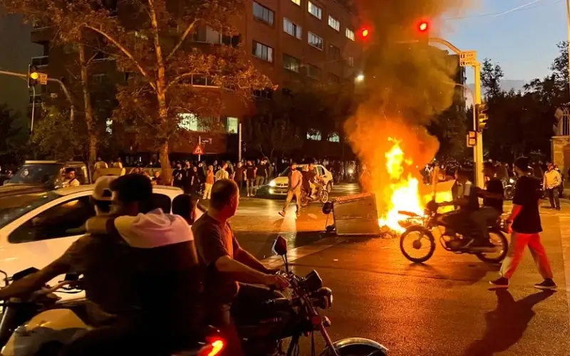 A police motorcycle burns during a protest over the death of Mahsa Amini, a woman who died after being arrested by the Islamic republic's "morality police", in Tehran, Iran September 19, 2022. (West Asia News Agency via Reuters//File Photo)
