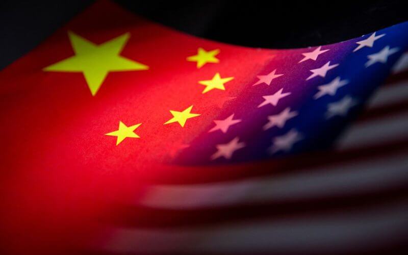 China's and U.S.' flags are seen printed on paper in this illustration taken January 27, 2022. REUTERS/Dado Ruvic/Illustration