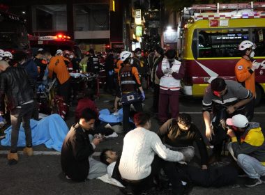 Rescue workers and firefighters try to help injured people near the scene of a crowd surge in Seoul, South Korea, Sunday, Oct. 30, 2022. AP