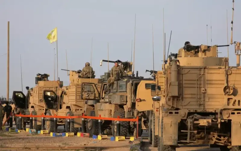 American soldiers stand near military trucks, at al-Omar oil field in Deir Al Zor, Syria March 23, 2019. (photo credit: REUTERS/RODI SAID)
