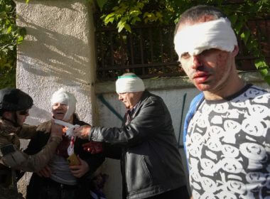 People receive medical treatment at the scene of Russian shelling, in Kyiv, Ukraine, Monday, Oct. 10, 2022. AP