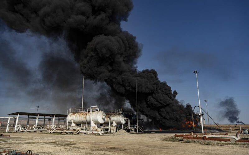 Smoke rises from an oil depot struck by the Turkish air force near the town of Qamishli, Syria, Wednesday, Nov. 23, 2022. (AP Photo/Baderkhan Ahmad)