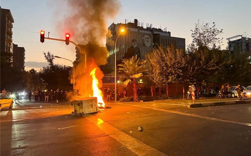 A police motorcycle burns during a protest over the death of Mahsa Amini, a woman who died after being arrested by the Islamic republic’s “morality police”, in Tehran, Iran September 19, 2022. WANA (West Asia News Agency) via REUTERS
