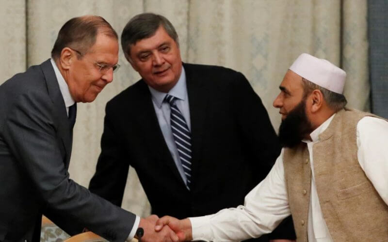 Russian Foreign Minister Sergei Lavrov welcomes member of Taliban delegation Alhaj Mohammad Sohail Shaina during earlier talks, Nov. 9, 2018. Russian officials have confirmed that there will be no participation by the Taliban government at the 2022 talks. Reuters