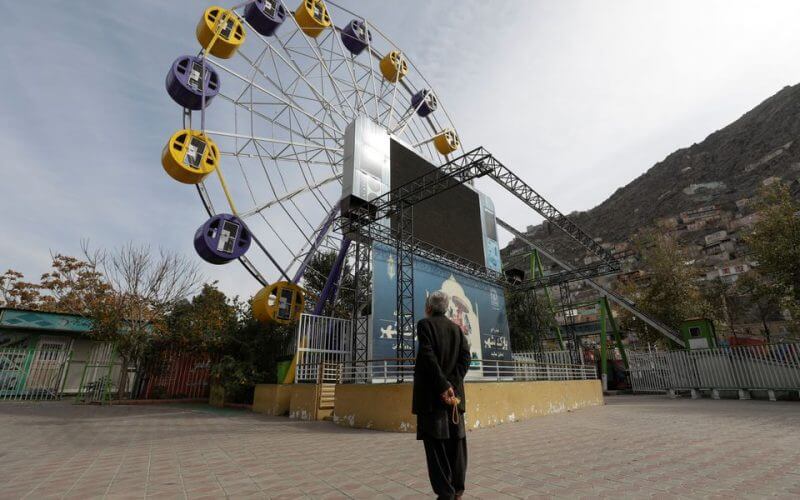 An Afghan man stands in an amusement park in Kabul, Afghanistan, November 9, 2022. REUTERS