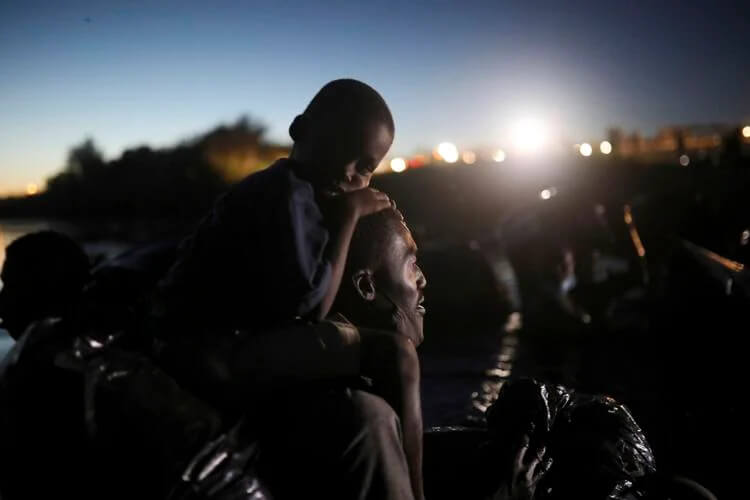 Migrants, most from Haiti, cross the Rio Grande towards Del Rio, Texas, from Ciudad Acuña, Mexico. Felix Marquez / AP Photo
