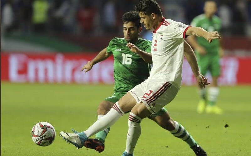Voria Ghafouri, then an Iranian national soccer team player, right, fights for the ball with Iraqi midfielder Hussein Ali, during the AFC Asian Cup soccer match at the Al Maktoum Stadium in Dubai, United Arab Emirates, Jan. 16, 2019. AP