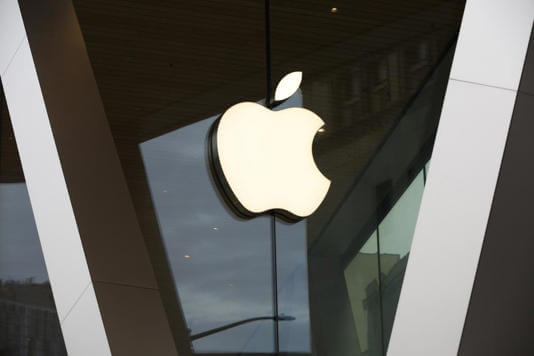 In this Saturday, March 14, 2020, file photo, an Apple logo adorns the facade of the downtown Brooklyn Apple store in New York. AP