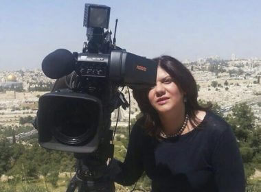 Shireen Abu Akleh stands next to a TV camera above the Old City of Jerusalem, in an undated photo. AP