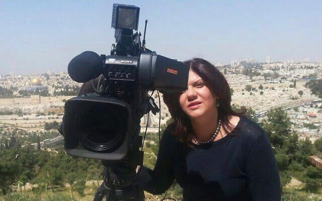 Shireen Abu Akleh stands next to a TV camera above the Old City of Jerusalem, in an undated photo. AP