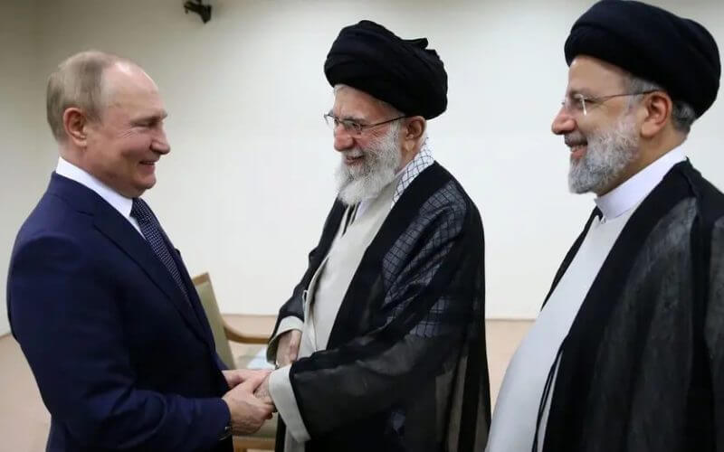 In this picture released by the official website of the office of the Iranian supreme leader, Supreme Leader Ayatollah Ali Khamenei, center, and Russian President Vladimir Putin, left, greet each other as Iranian President Ebrahim Raisi stands at right, during their meeting in Tehran, Iran, Tuesday, July 19, 2022. (Office of the Iranian Supreme Leader via AP)