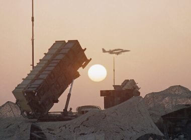 Illustrative: A pair of F-16 fighter jets streak past a Patriot Missile Defense Battery as the sun sets, at an airbase in Saudi Arabia, October 8, 1990. (John Gaps/AP)