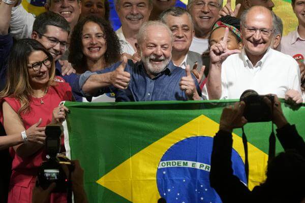 Former Brazilian President Luiz Inacio Lula da Silva celebrates with his wife Rosangela Silva, left, and running mate Geraldo Alckmin, right, after defeating incumbent Jair Bolsonaro in a presidential run-off to become the country's next president, in Sao Paulo, Brazil, Sunday, Oct. 30, 2022. (AP Photo/Andre Penner)