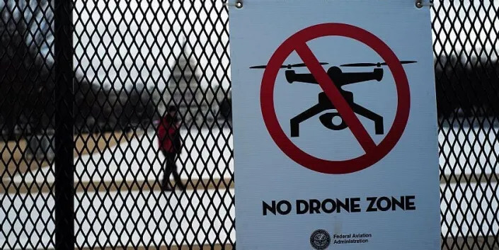 A sign reading "No Drone Zone" is placed on a security fence at the National Mall in Washington, DC.JEWEL SAMAD/AFP via Getty Images