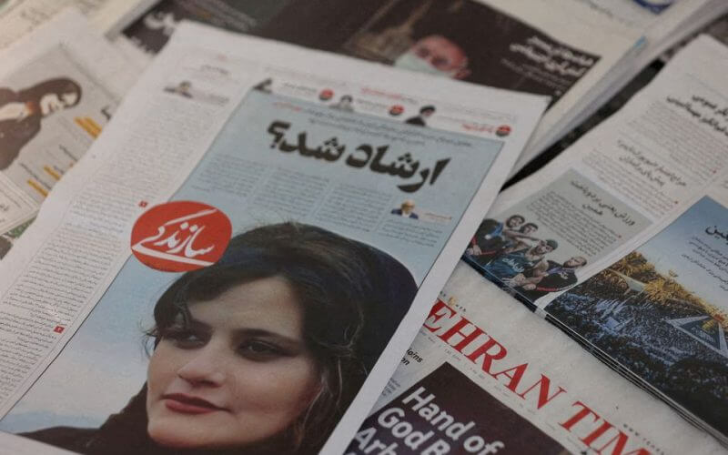 A newspaper with a cover picture of Mahsa Amini, a woman who died after being arrested by Iranian morality police is seen in Tehran, Iran, September 18, 2022. Majid Asgaripour/WANA (West Asia News Agency) via REUTERS