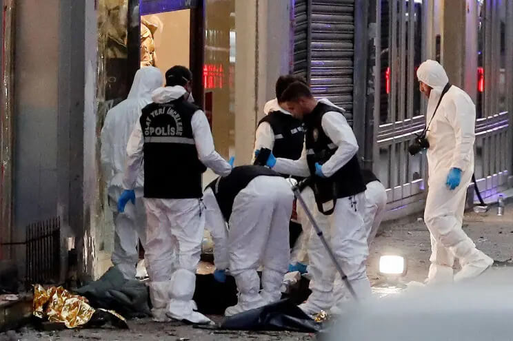 Police work near the bodies of unidentified victims of the attack on a popular market in Istanbul. REUTERS