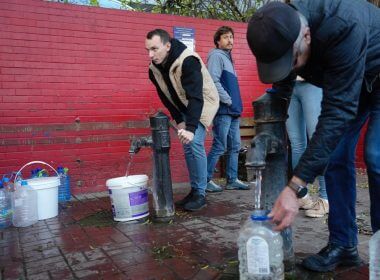 People fill containers with water from public water pumps in Kyiv, Ukraine, Monday, Oct. 31, 2022. AP