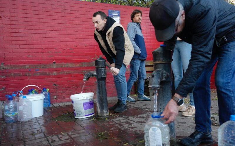 People fill containers with water from public water pumps in Kyiv, Ukraine, Monday, Oct. 31, 2022. AP