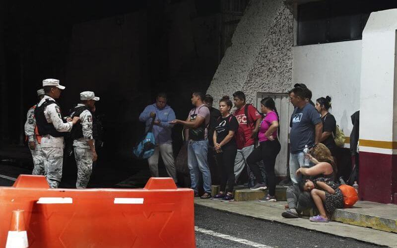 Venezuelan migrants are stopped by the National Guard at an army checkpoint on the road to Tonala, Chiapas state, Mexico, Wednesday, Oct. 5, 2022. AP
