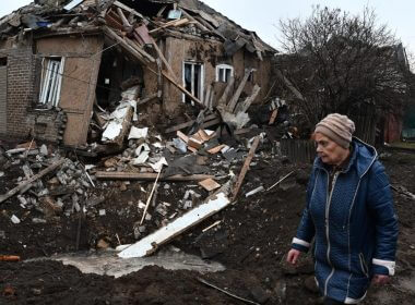 A woman walks past her house that was damaged in Russian shelling in Kramatorsk, Ukraine, Saturday, Nov. 19, 2022. (AP Photo/Andriy Andriyenko)