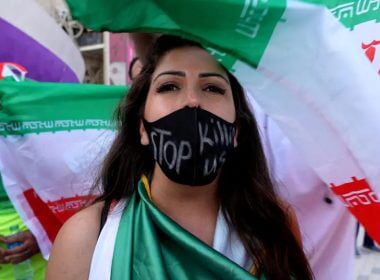 A woman wearing a facemask with a message reading 'stop killing us' after the Wales v Iran match. (photo credit: REUTERS/CHARLOTTE BRUNEAU)