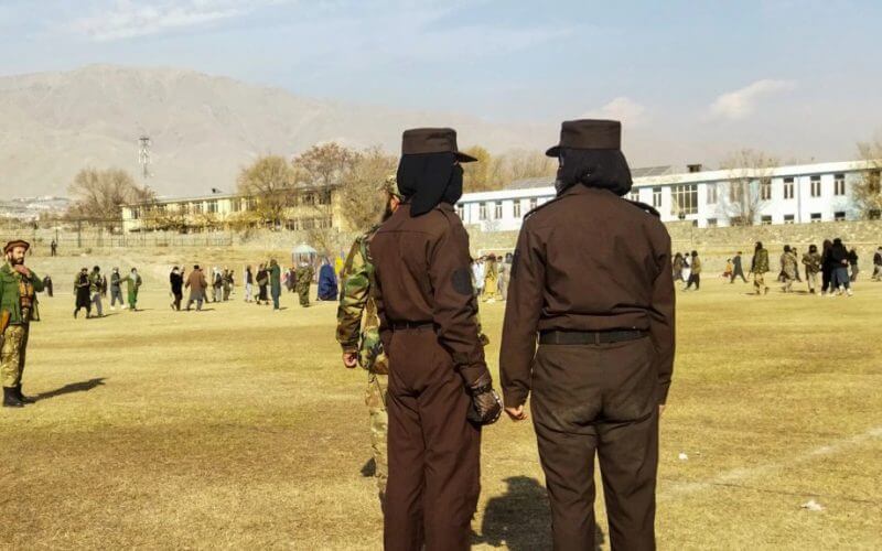 Taliban security personnel stand guard ahead of the public flogging of women and men at a football stadium in Charikar city of Parwan province, Dec. 8, 2022. AFP