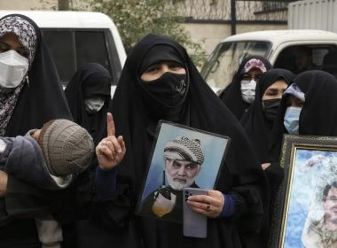 An Iranian woman holds a portrait of the late Revolutionary Guard Gen. Qassem Soleimani, who was killed in Iraq in a U.S. drone attack in 2020, in a pro-government demonstration in front of the United Nation's office in Tehran, Iran, Tuesday, Dec. 13, 2022. AP