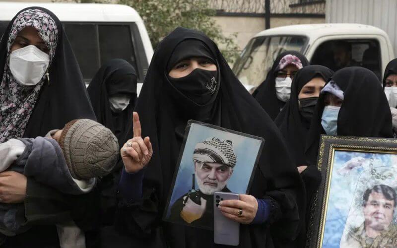 An Iranian woman holds a portrait of the late Revolutionary Guard Gen. Qassem Soleimani, who was killed in Iraq in a U.S. drone attack in 2020, in a pro-government demonstration in front of the United Nation's office in Tehran, Iran, Tuesday, Dec. 13, 2022. AP