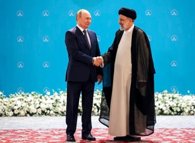 Russian President Vladimir Putin (L) and Iranian President Ebrahim Raisi shake hands in Tehran, Iran. AP