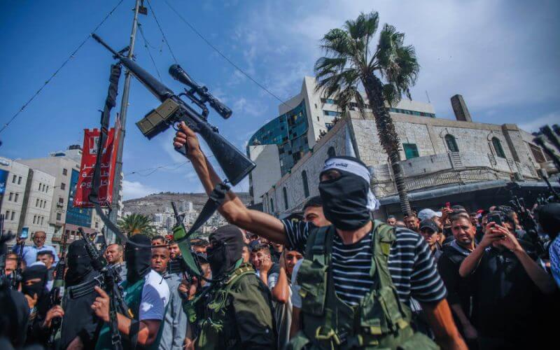 Gunmen seen shooting in air during the funeral of five Palestinians who were killed in an Israeli night raid in Nablus, Oct. 25, 2022 (Photo: Nasser Ishtayeh/SOPA Images/Sipa USA)