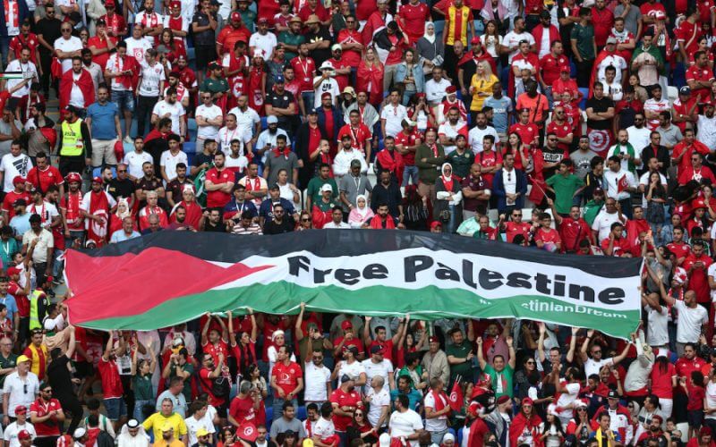 Fans unveil a banner with the message 'Free Palestine' at a match between Tunisia and Australia during the World Cup in Qatar, Nov. 26, 2022 (Photo: REUTERS/Marko Djurica)