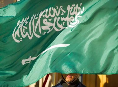 An honor guard member is covered by the flag of Saudi Arabia in Washington, the United States. AP