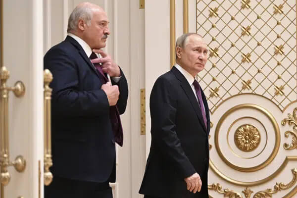 Russian President Vladimir Putin, right, and Belarusian President Alexander Lukashenko enter a hall after their talks in Minsk, Belarus, Monday, Dec. 19, 2022. (Pavel Bednyakov, Sputnik, Kremlin Pool Photo via AP)