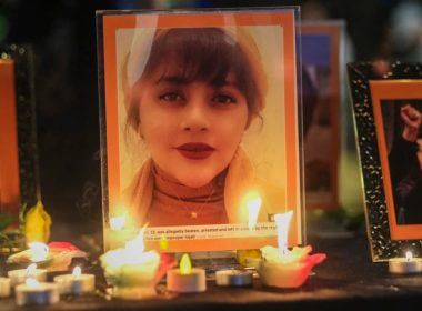 Candles and pictures of Mahsa Amini are shown during a vigil in Los Angeles for Mahsa Amini, who died in custody of Iran's morality police, Sept. 29, 2022. AFP