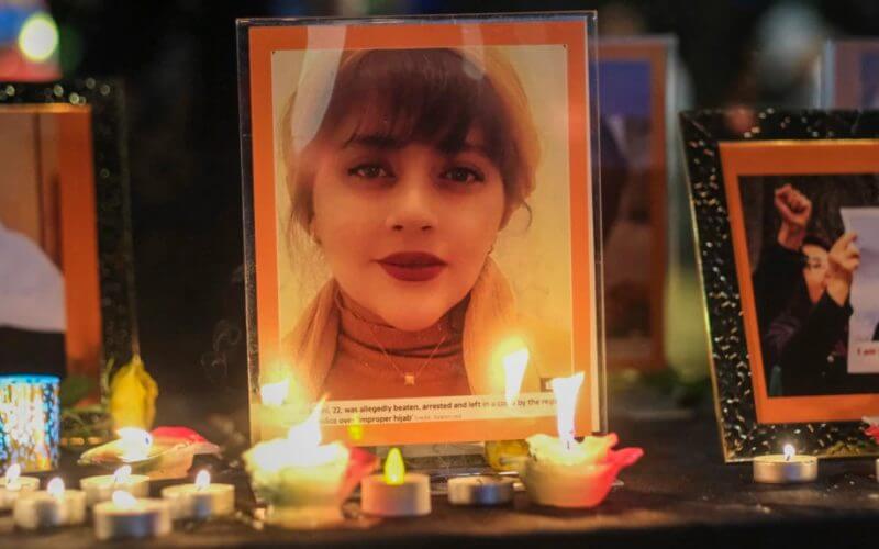 Candles and pictures of Mahsa Amini are shown during a vigil in Los Angeles for Mahsa Amini, who died in custody of Iran's morality police, Sept. 29, 2022. AFP
