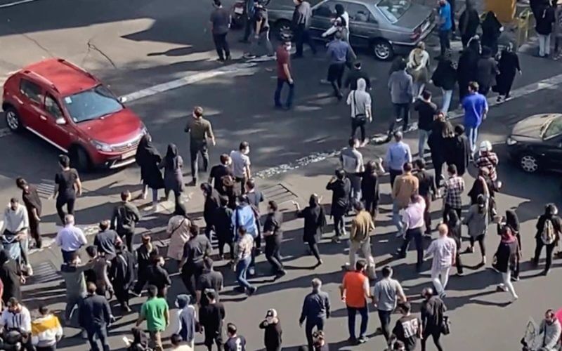 In this frame grab from video taken by an individual not employed by the Associated Press and obtained by the AP outside Iran shows people blocking an intersection during ongoing anti-government protests, in Tehran, Iran, Oct. 26, 2022. AP