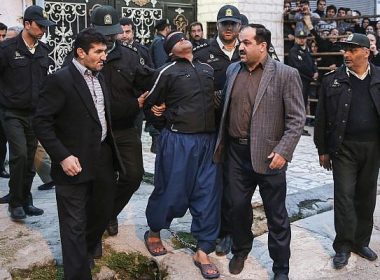 This Tuesday, April 15, 2014, file photo provided by ISNA, a semi-official news agency, shows blindfolded Iranian convicted man Bilal being escorted by officials and security to be prepared for his execution in public in the northern city of Nour, Iran. (AP/ISNA, Arash Khamoushi)