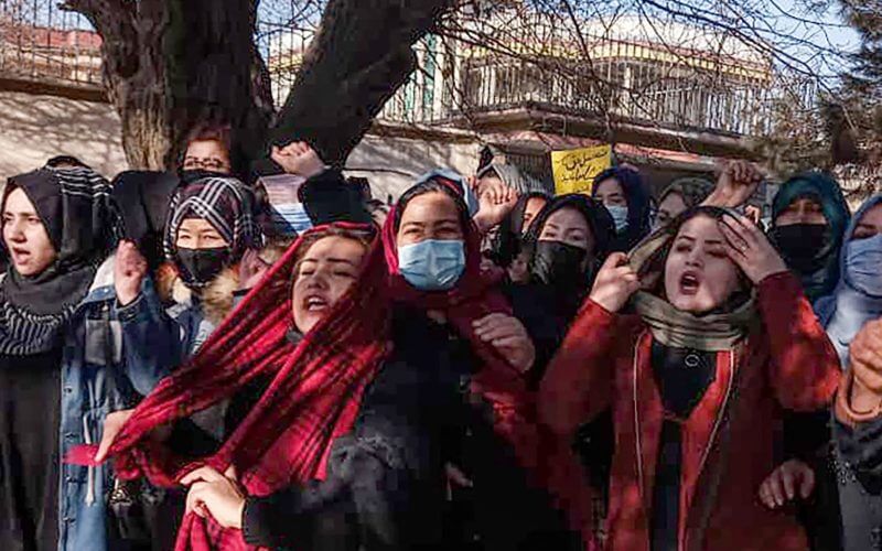 Afghan women chant slogans to protest against the ban on university education for women, in Kabul on December 22, 2022. (Photo by -/AFP via Getty Images)