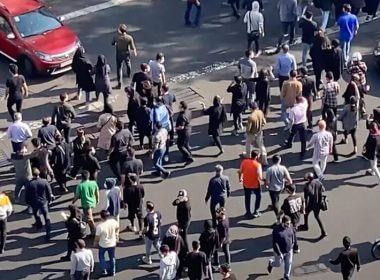 In this frame grab from a video, people are blocking an intersection during a protest to mark 40 days since the death in custody of 22-year-old Mahsa Amini, whose tragedy sparked Iran's biggest antigovernment movement in over a decade, in Tehran, Iran, Wednesday, Oct. 26, 2022. (AP Photo)