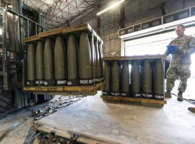 U.S. Air Force Staff Sgt. Cody Brown, right, with the 436th Aerial Port Squadron, checks pallets of 155 mm shells ultimately bound for Ukraine, April 29, 2022, at Dover Air Force Base, Del. AP