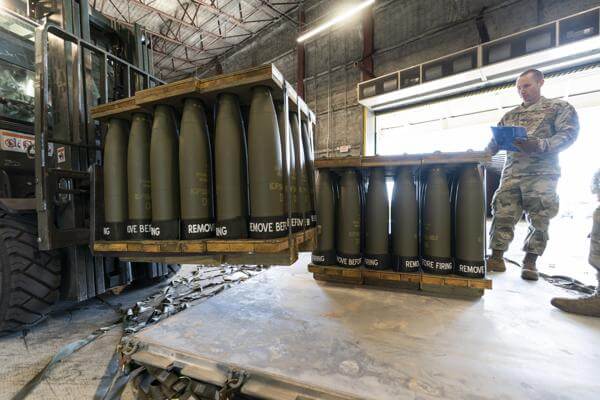 U.S. Air Force Staff Sgt. Cody Brown, right, with the 436th Aerial Port Squadron, checks pallets of 155 mm shells ultimately bound for Ukraine, April 29, 2022, at Dover Air Force Base, Del. AP
