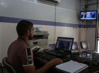 Palestinians watch television and use the computer in Khan Younis in the southern Gaza Strip. Abed Rahim Khatib/ Flash90
