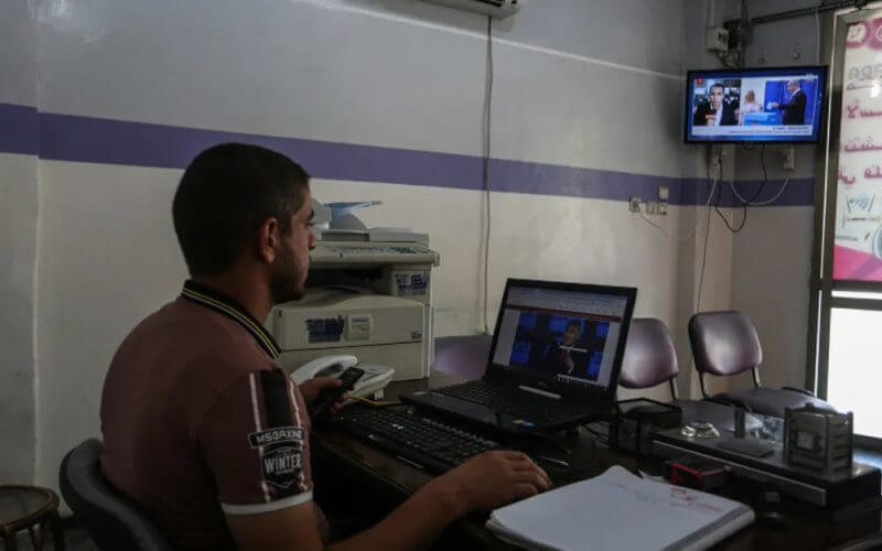 Palestinians watch television and use the computer in Khan Younis in the southern Gaza Strip. Abed Rahim Khatib/ Flash90