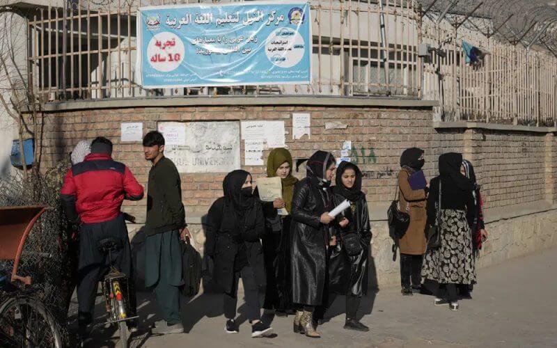 Afghan women students stand outside the Kabul University in Kabul, Afghanistan, Wednesday, Dec. 21, 2022. AP