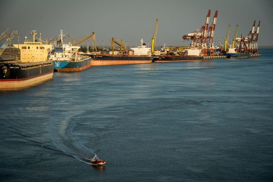 Cargo vessels and container ships sitting at dockside during loading operations at the port in Bandar Imam Khomeini, Iran. PHOTO: ALI MOHAMMADI/BLOOMBERG NEWS