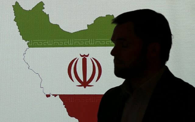 A cybersecurity expert stands in front of a map of Iran as he speaks to journalists about the techniques of Iranian hacking, on September 20, 2017, in Dubai, United Arab Emirates. (AP/Kamran Jebreili)