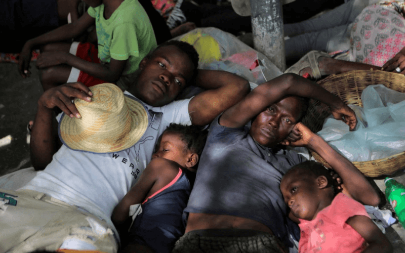 FILE - People displaced by gang war violence in Cite Soleil rest on the streets of Delmas neighborhood after leaving Hugo Chavez Square in Port-au-Prince, Haiti, Nov. 19, 2022.