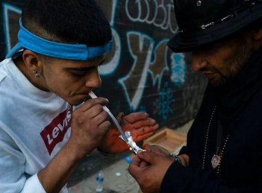 Two homeless addicts share a small piece of fentanyl in an alley in Los Angeles last August. AP