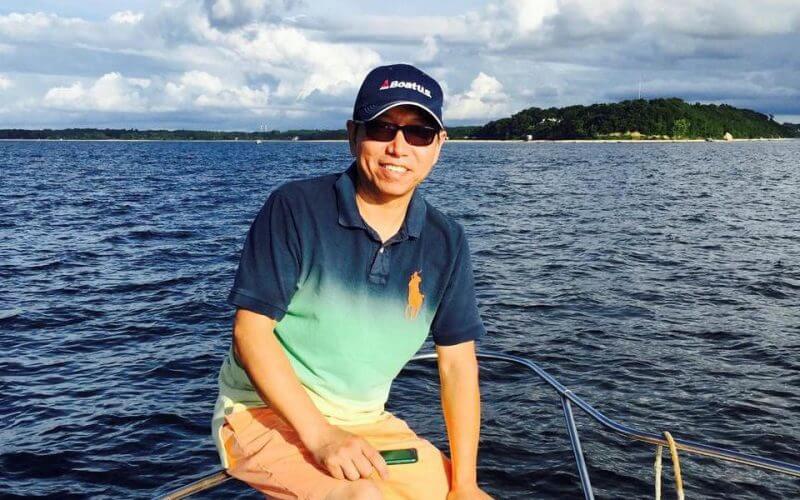 Chinese-American citizen Kai Li, who has been detained in China since 2016, poses for a picture while fishing on the Long Island Sound in New York, U.S., August 23, 2015, in this handout picture. Harrison Li/Handout via REUTERS